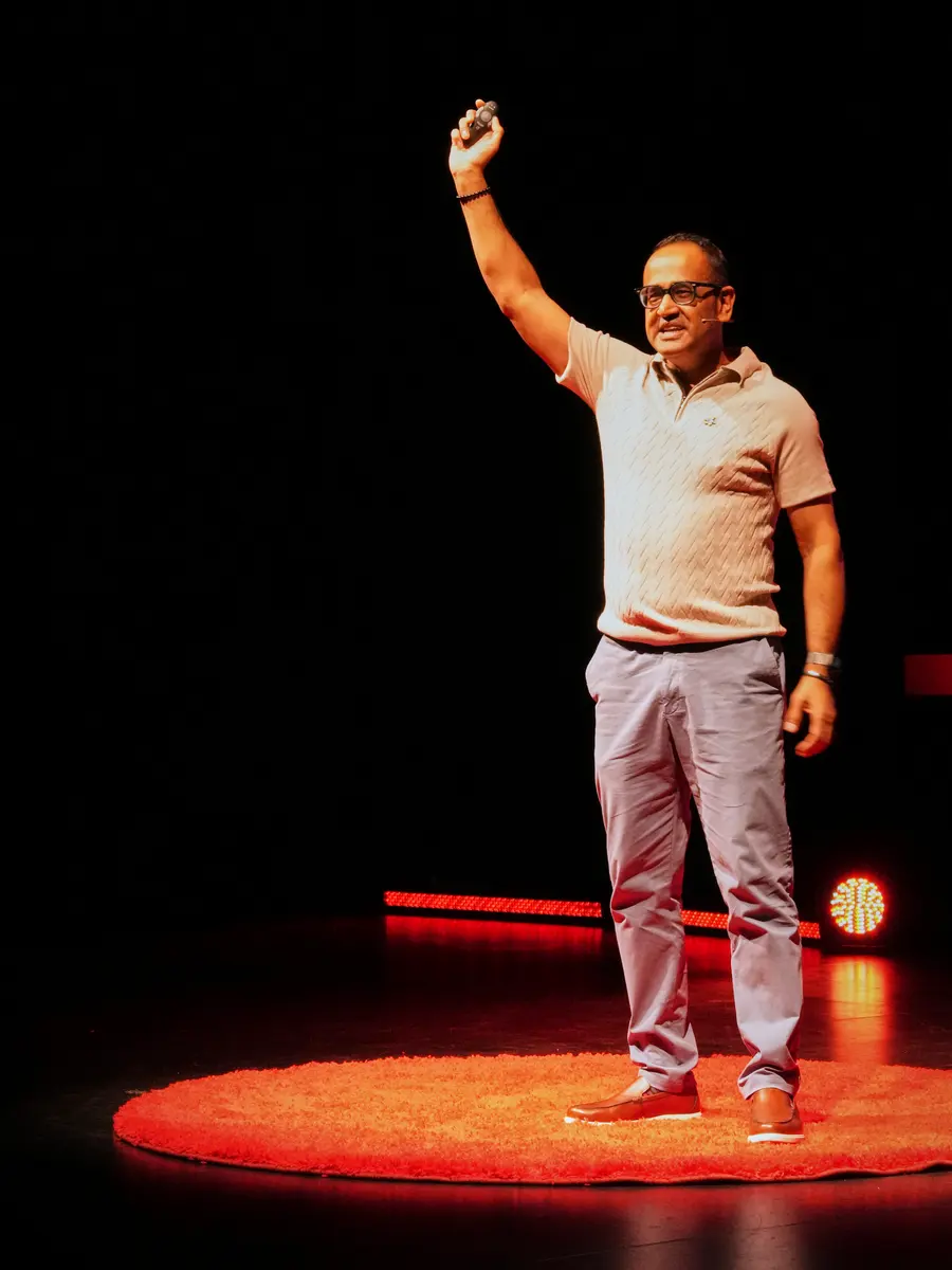 Chetan Joshi on stage at TEDxMoseley delivering a talk on human-centred AI
